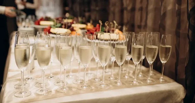 Rows of champagne flutes at a wedding.