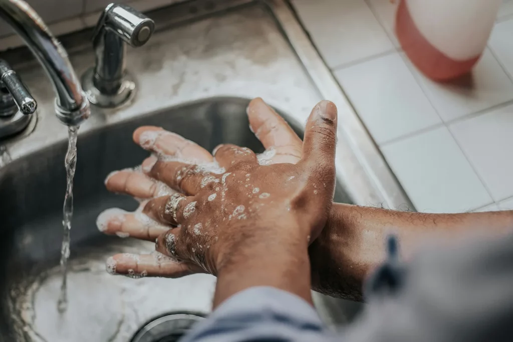 A close-up of a man washing his hands.